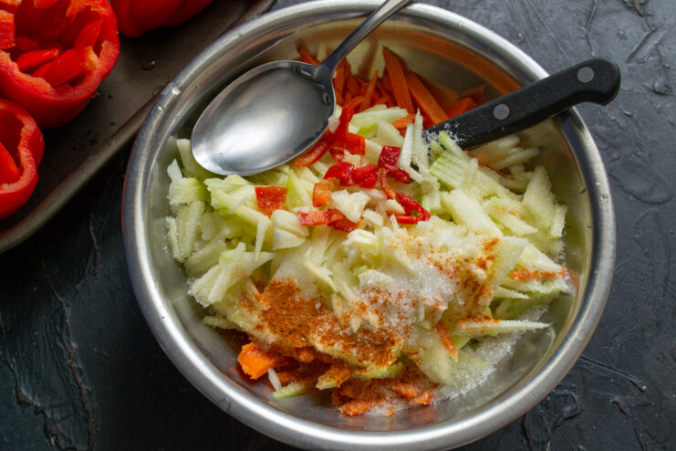 Preparing the vegetable filling Vegetable filling mixture with zucchini, garlic, and spices in a bowl