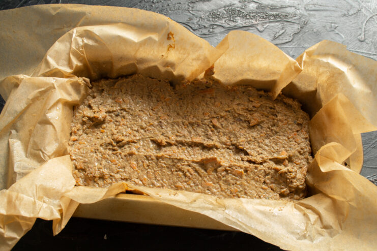 Preparing to bake Smooth pate mixture spread evenly into a parchment-lined rectangular baking dish.