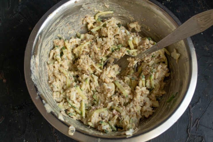 Mixing the ingredients Mixed fish and rice salad in a large bowl