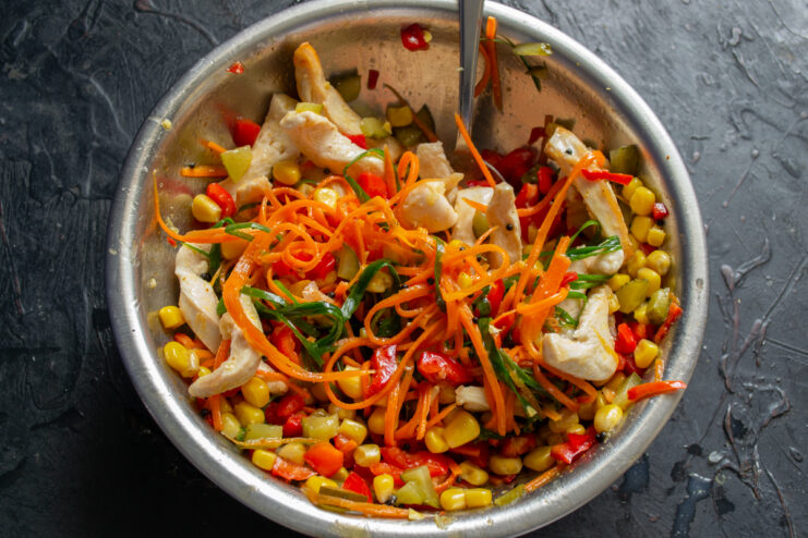 Mixing The Salad Tossing all the salad ingredients together in a large bowl
