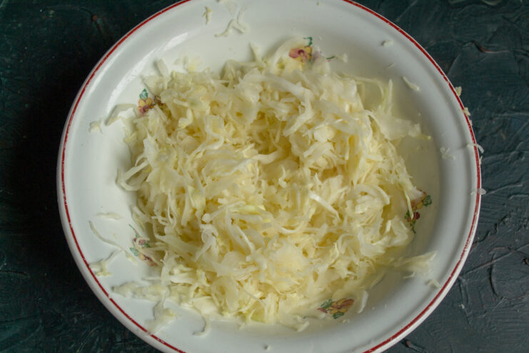 Massaging the cabbage with salt Massaged shredded cabbage with salt in a bowl releasing natural juices