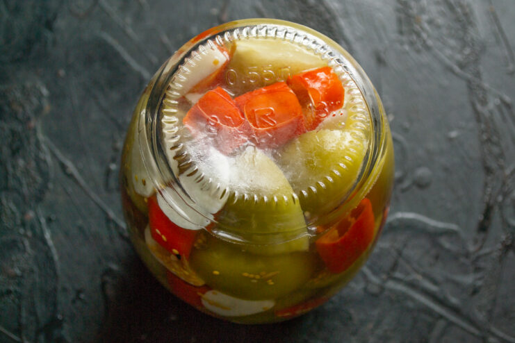 Sterilizing and cooling Inverted glass jar of pickled physalis resting to cool down