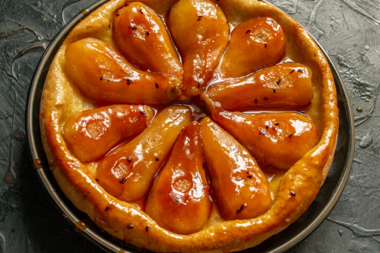 Flipping the Tart Freshly inverted upside-down pear tart steaming on a serving plate