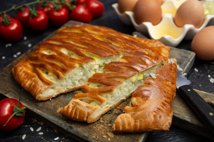 Sliced rice and egg pie on a wooden cutting board