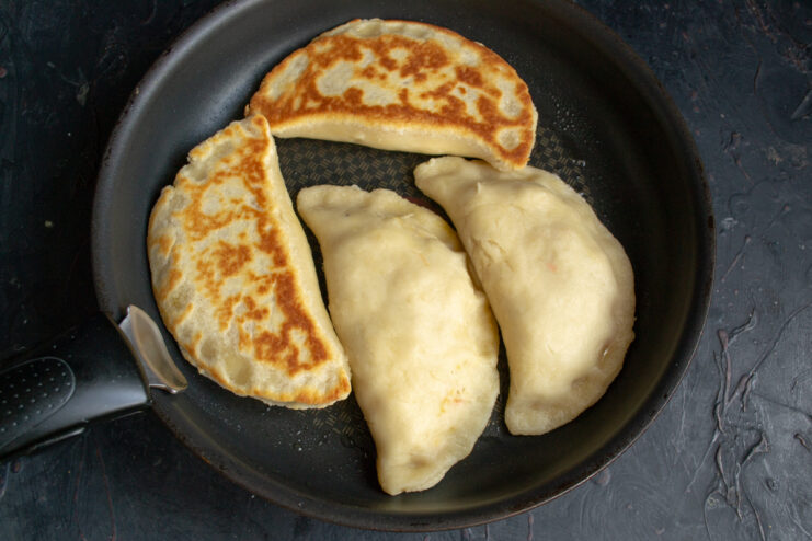 Frying the hand pies in a skillet Hand pies frying in a skillet until golden and crispy