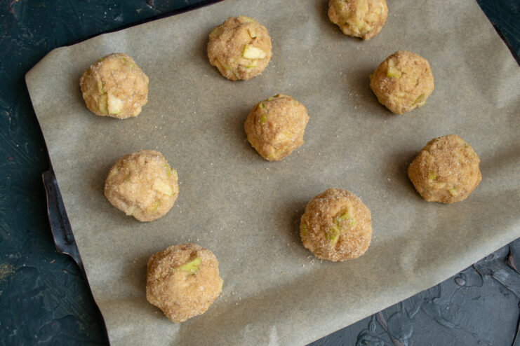 Arranged dough balls on a parchment-lined baking sheet