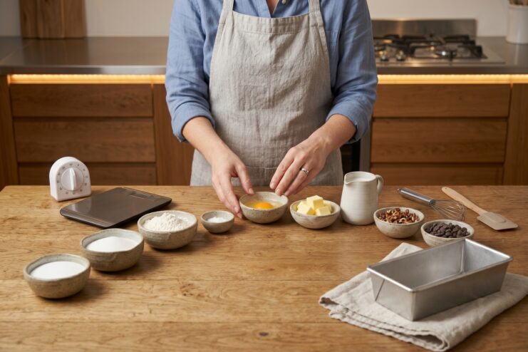 Mise en place workspace organization Prepped ingredients in bowls, a kitchen scale, and a timer arranged neatly on a countertop.