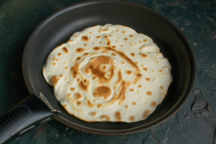 Toasted flatbread cooking in a skillet