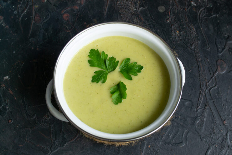 Top-down view of a serving of green bean purée soup in a bowl