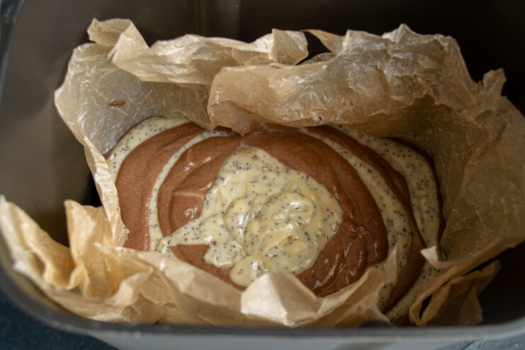 Creating The Zebra Pattern Layering poppy seed and chocolate batter in a parchment lined pan