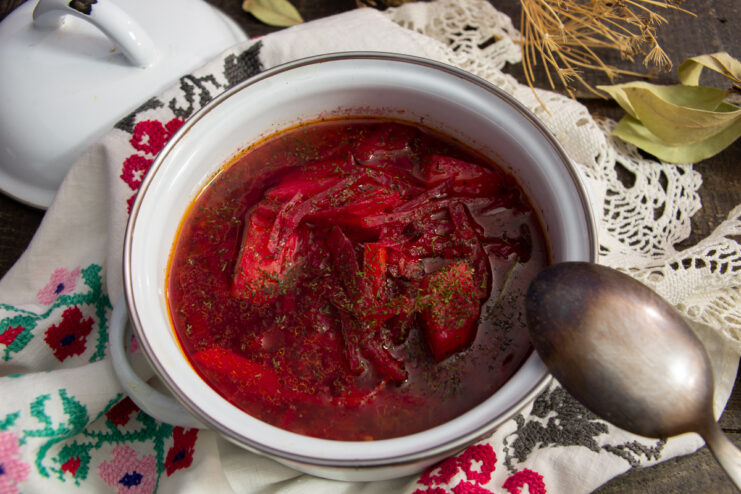 Vegan borscht with sauerkraut in a white pot