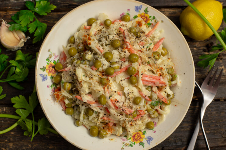 Plated vegan vegetable salad with green peas and cabbage garnished with paprika