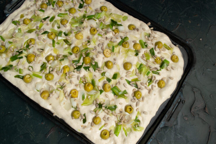 Final touches Sprinkling sunflower seeds over the focaccia dough