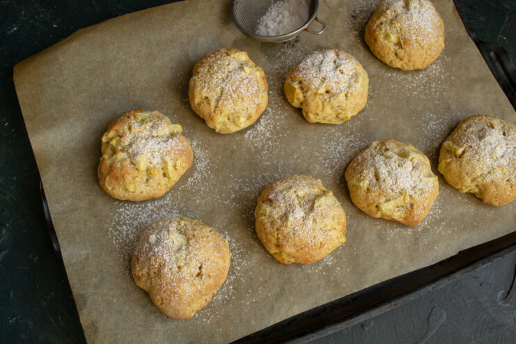 Dusting warm baked cookies with powdered sugar through a fine mesh sieve