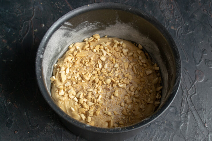 Nut topping Sprinkling chopped cashews and sugar over the cake batter