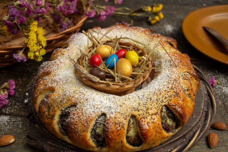 Festive yeast dough poppy seed ring cake decorated with Easter eggs