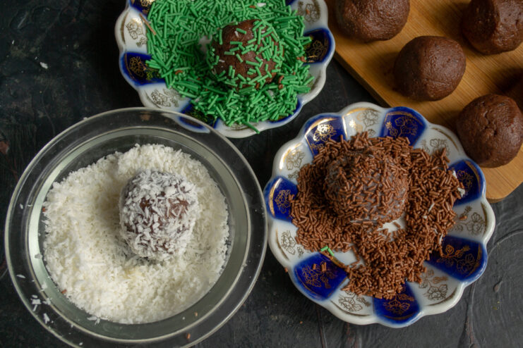 Rolling chocolate balls in shredded coconut and candy sprinkles.