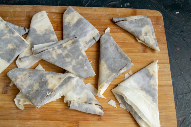 Folding Samosas Folding a strip of filled dough into a triangle shape