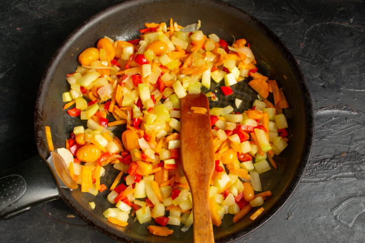 Vegetable ratatouille simmering in an open skillet.
