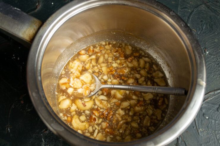 Preparing The Syrup Warming honey nut syrup in a saucepan