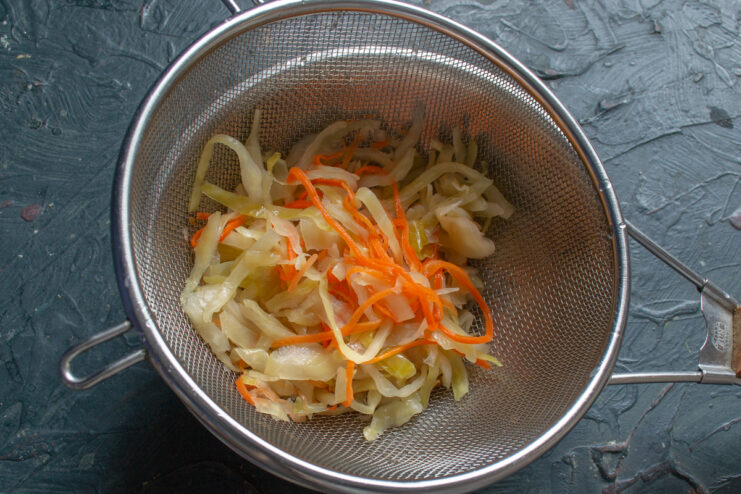 Prepping the sauerkraut Rinsed sauerkraut draining in a fine metal sieve