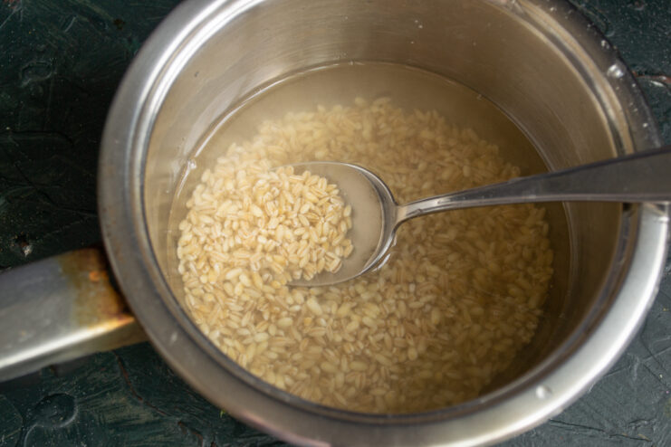 Rinsing the pearl barley Rinsed pearl barley soaking in a pot of clear water