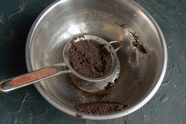 Rinsing Poppy Seeds Rinsed poppy seeds in a fine-mesh sieve over a bowl