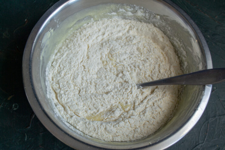 Incorporating Flour Sifting flour and baking powder into the bowl of wet ingredients
