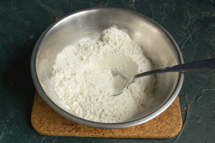 Sifting flour into a large mixing bowl