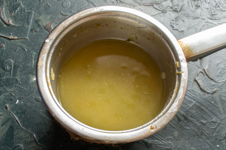 Preparing the Broth Base Clear chicken broth coming to a gentle boil in a small saucepan.
