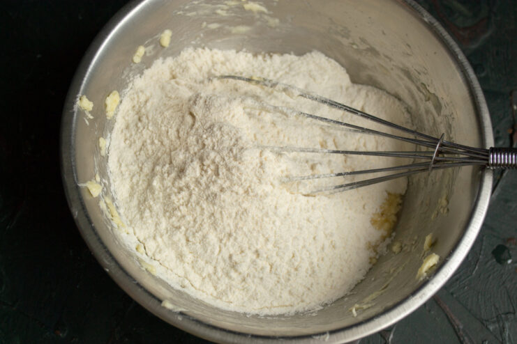 Mixing the Dough All-purpose flour piled on top of the butter mixture in a metal bowl