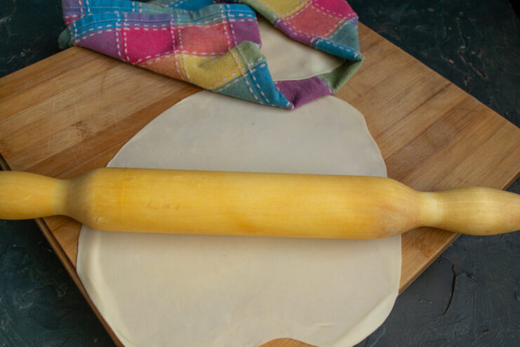 Rolling out dough with a wooden rolling pin