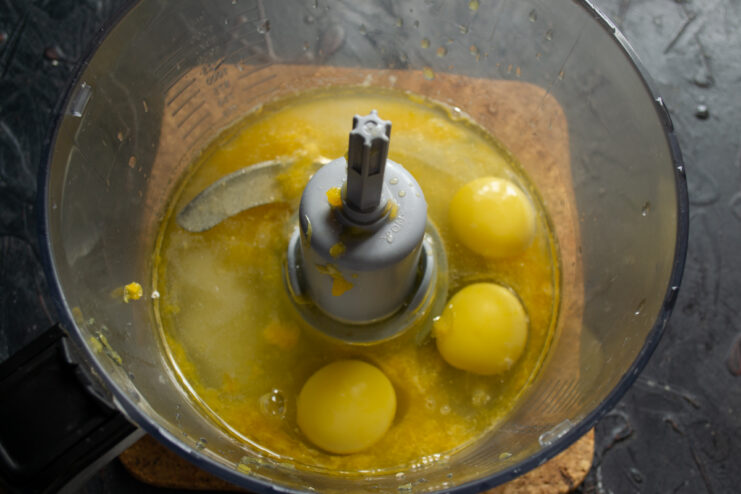 Pouring in the oil Adding vegetable oil to the cake mixture