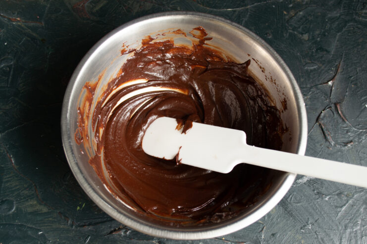 Melted chocolate base Melted dark chocolate and butter mixed in a glass bowl