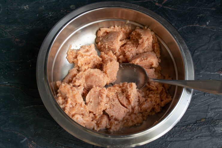 Minced fish preparation Thawed minced fish in a metal mixing bowl.