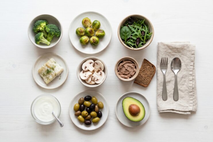 Commonly Disliked Foods by Children Various healthy ingredients arranged on plates, including broccoli, fish, liver, avocado, and chopped mushrooms.