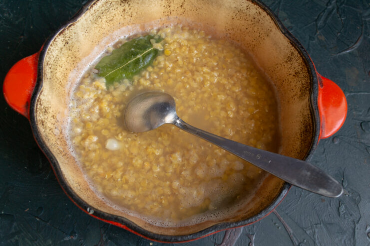Simmering Lentils for a Thick Base Fully cooked red lentils broken down in a pot