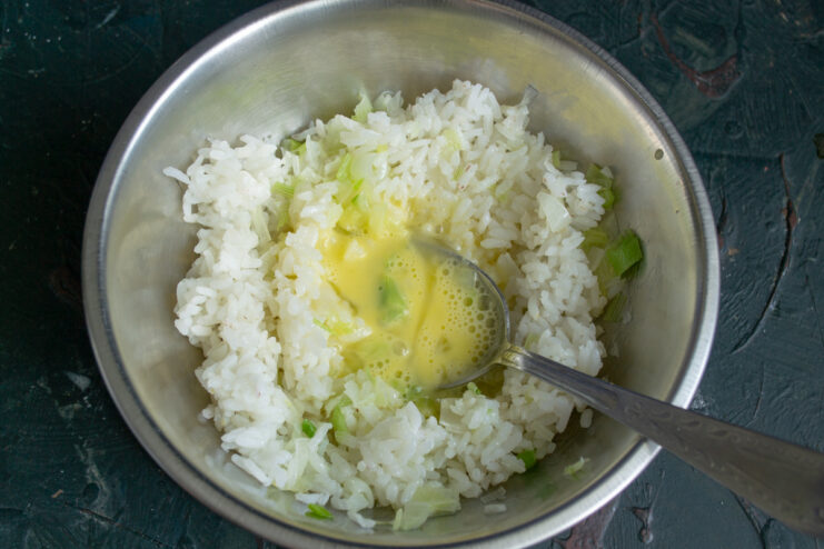 Adding sauteed leeks to the dumpling mixture