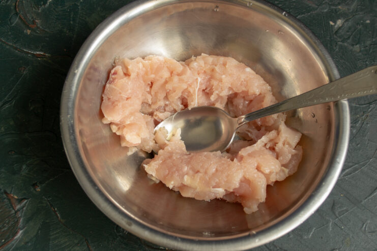 Chopping raw meat with a knife to retain texture and juiciness