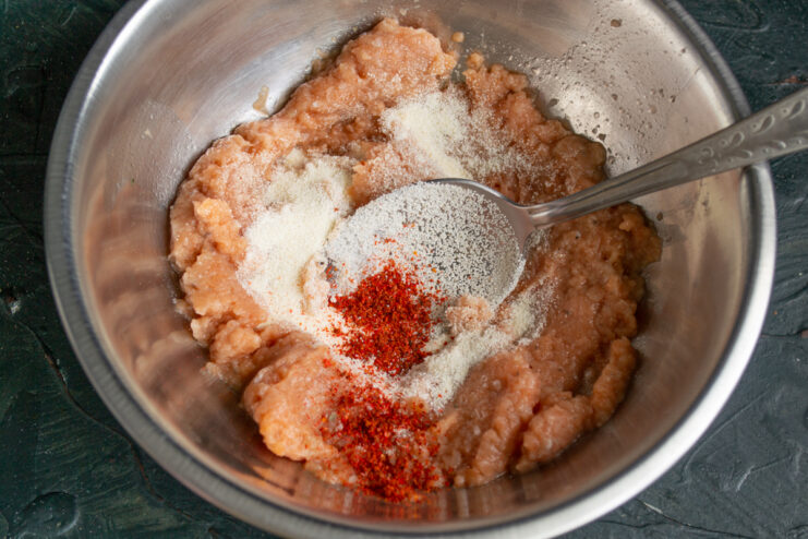 Mixing the fish meatball base Minced fish mixed with semolina and bright red paprika