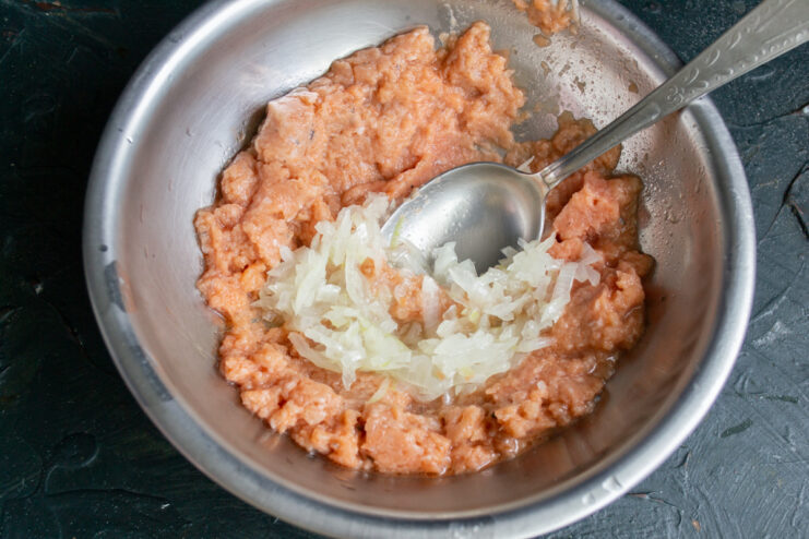 Preparing minced salmon with onion Minced salmon mixed with chopped onion in a bowl