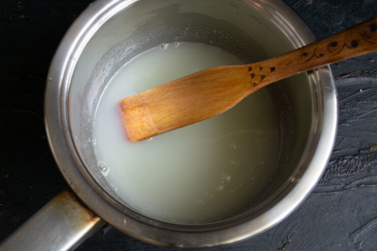 Preparing the cream base Granulated sugar and cream mixed in a small saucepan on the stove
