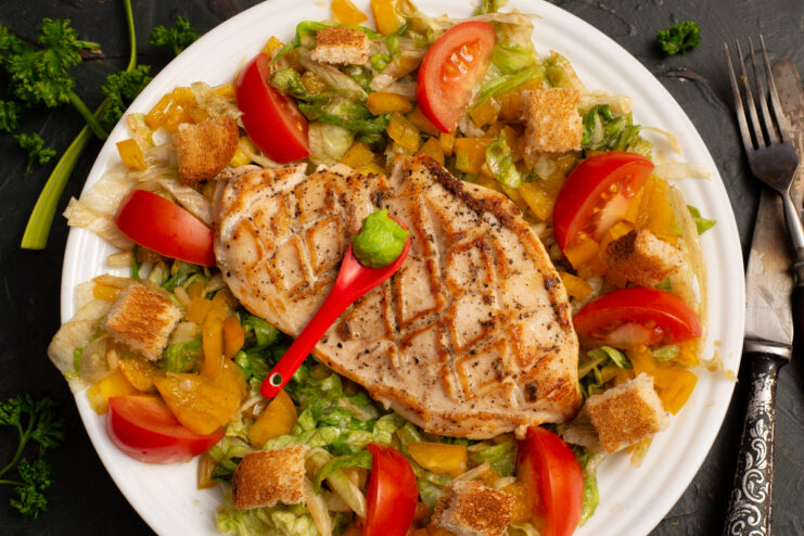 Pan-seared chicken and vegetable salad served on a plate