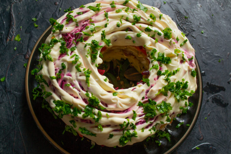 Salad garnish Shuba salad garnished with a mayonnaise pattern and fresh parsley leaves