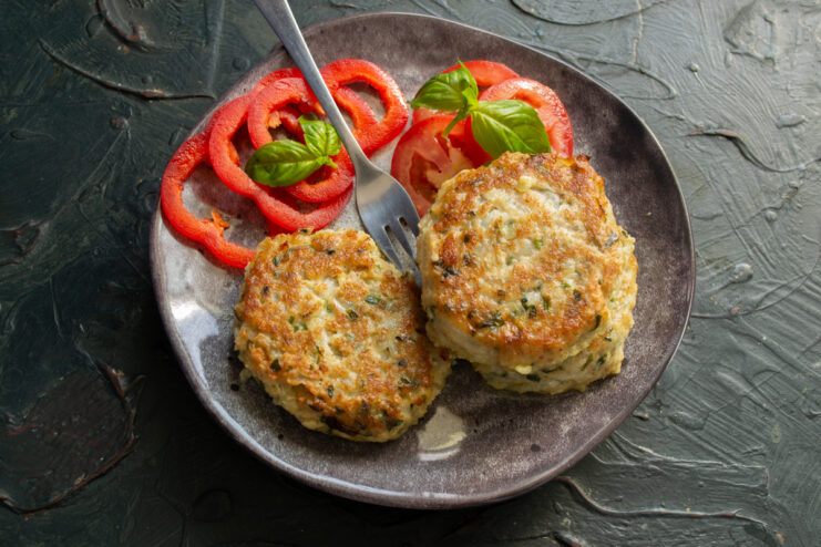 Serving the Dish Plated oat patties garnished with fresh bell peppers and tomatoes