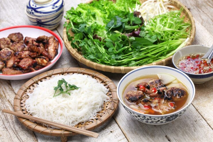 Bun cha set with grilled pork and rice noodles Bun cha meal set featuring grilled pork, thin rice noodles, fresh herbs, and dipping sauce.