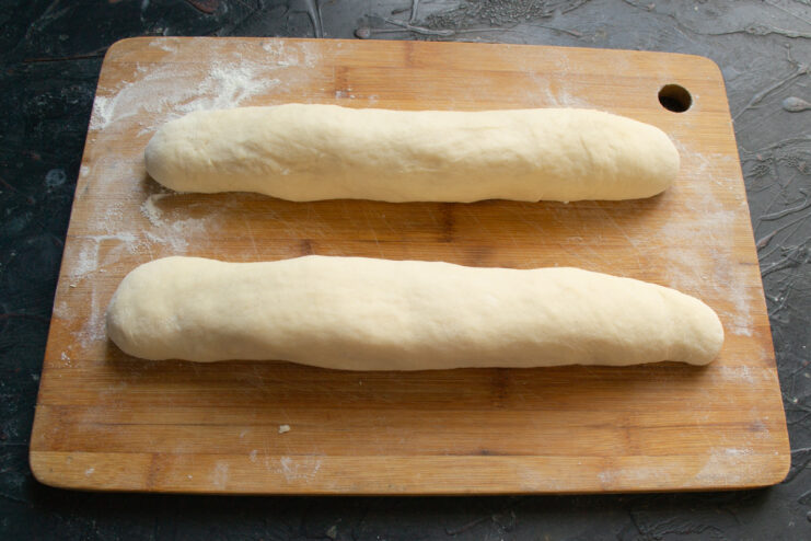 Rolling filled dough into tight logs and sealing the edges