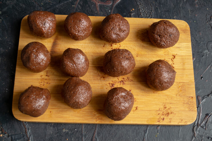 Shaped chocolate balls on a wooden board.
