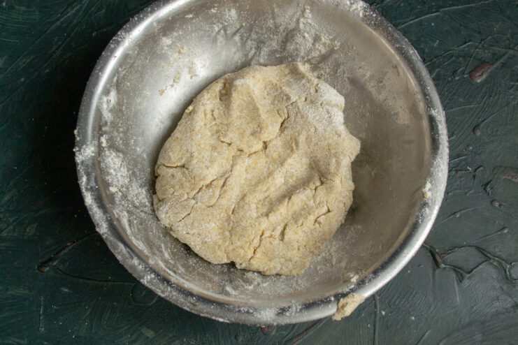 Kneading the Dough A ball of prepared rye dough resting in a bowl