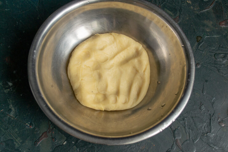 Kneaded dough A ball of kneaded shortcrust pastry dough in a metal bowl